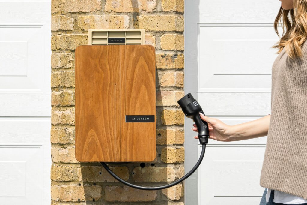 pexels-photo-27355833-27355833 Wooden EV home charger installed on a brick wall for sustainable transportation.